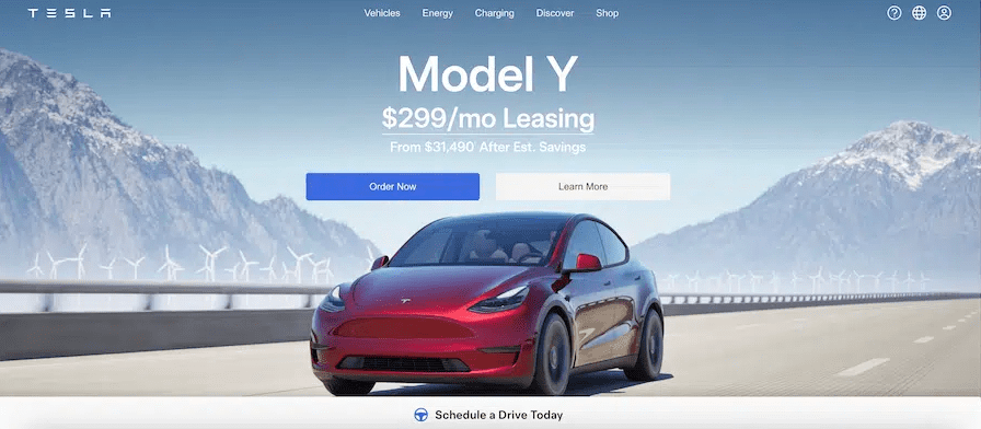 Tesla website homepage featuring a red Model Y driving on a road with mountains and wind turbines in the background. The text displays promotional leasing details with "Order Now" and "Learn More" buttons.
